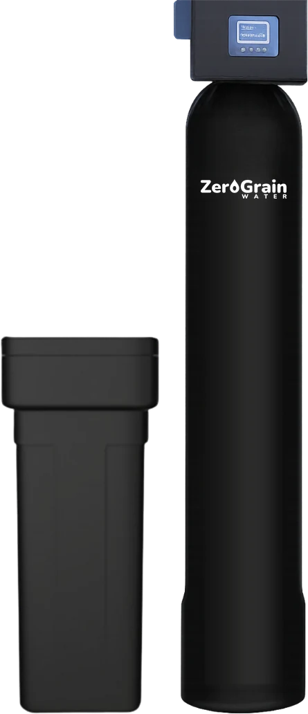 A softener's tall black tank and control valve next to the black brine tank that feeds it salt